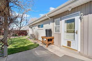 Doorway to property with a patio area