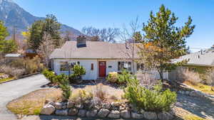 Single story home with a mountain view, a chimney, and roof with shingles