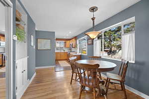 Dining area with light wood-style floors, a textured ceiling, and recessed lighting
