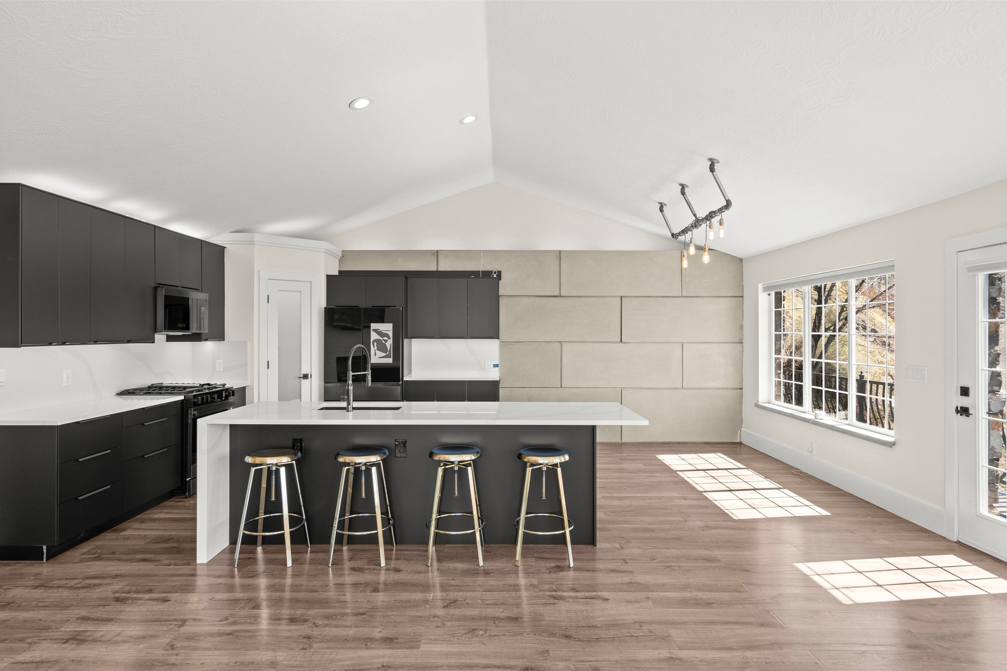Kitchen with dark cabinets, modern cabinets, and a breakfast bar area