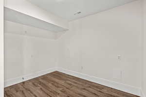 Spare room featuring wood finished floors and baseboards
