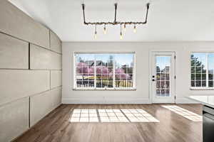 Unfurnished dining area featuring wood finished floors and a textured ceiling
