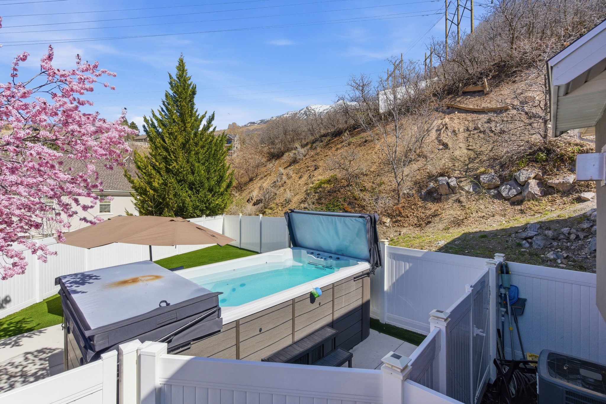 Wooden deck featuring a fenced backyard and a hot tub