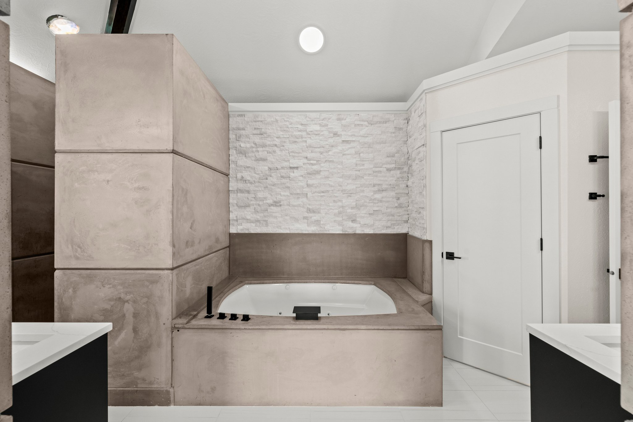 Bathroom featuring vanity, a bath, and light tile patterned floors