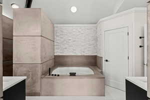 Bathroom featuring vanity, a bath, and light tile patterned floors