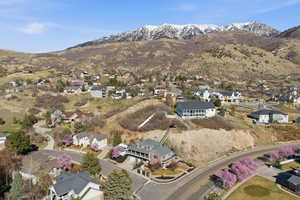View of property location featuring nearby suburban area and a mountain backdrop