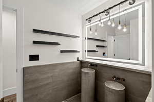 Bathroom with tile walls and wainscoting