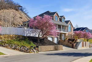View of front of property with a balcony and an attached garage