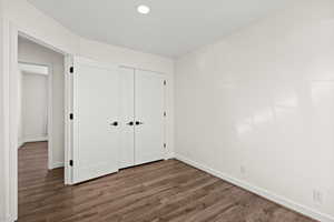 Unfurnished bedroom with dark wood finished floors, a closet, and recessed lighting