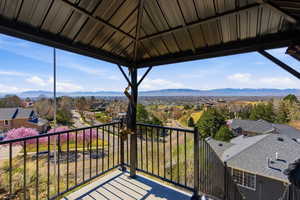 Balcony featuring a residential view, a mountain view, and a gazebo
