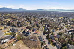 Aerial view of property's location featuring nearby suburban area and a mountainous background