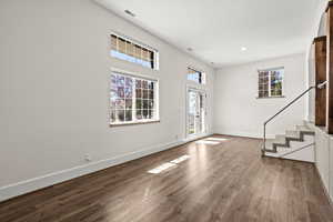 Entrance foyer with stairs and dark wood finished floors