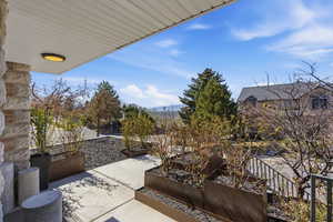 View of patio with a garden and a mountain view