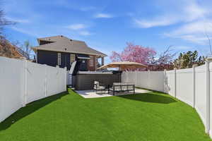 Fenced backyard with a gate and a patio