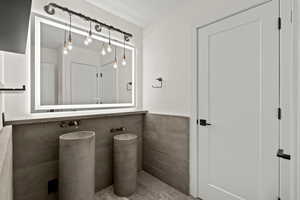 Bathroom featuring tile walls and wainscoting