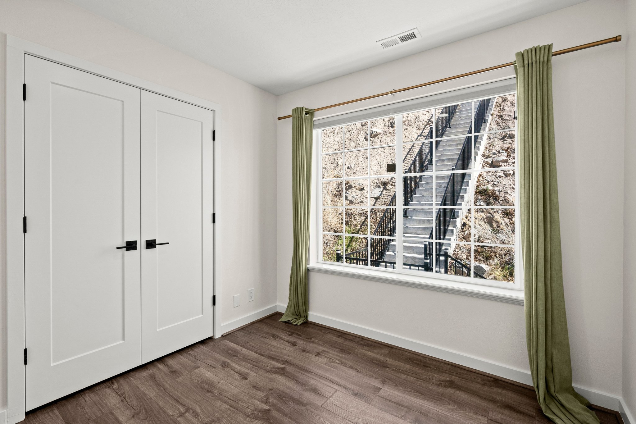 Unfurnished bedroom with dark wood-style flooring and a closet