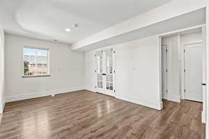 Unfurnished room featuring light wood finished floors, french doors, and recessed lighting