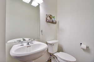 Half bathroom featuring toilet and a sink