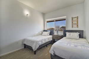 Bedroom featuring carpet and baseboards