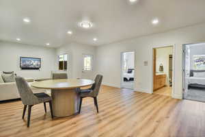 Dining area with light wood-type flooring and recessed lighting