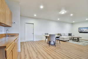 Living room featuring light wood finished floors and recessed lighting