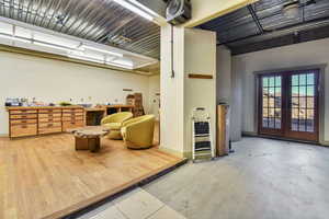 Sitting room with french doors and baseboards
