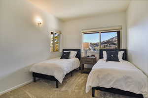 Bedroom featuring carpet and baseboards