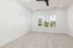 Unfurnished room featuring light carpet, ceiling fan, and recessed lighting