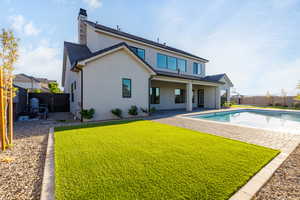 Rear view of house featuring a patio, a fenced backyard, and stucco siding