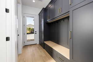 Mudroom with light wood-style flooring and recessed lighting