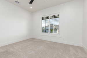 Empty room featuring light colored carpet, recessed lighting, and ceiling fan