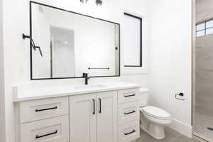 Full bath with vanity, a walk in shower, and light tile patterned floors