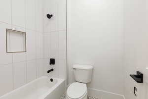 Full bath featuring toilet and  shower combination