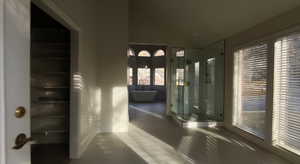 Corridor with lofted ceiling and dark tile patterned flooring