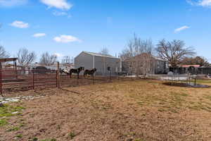 View of yard featuring a trampoline and a residential view