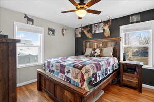 Bedroom with hardwood / wood-style floors and ceiling fan