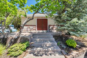 Entrance to property with stucco siding