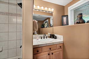 Bathroom featuring vanity and a textured wall