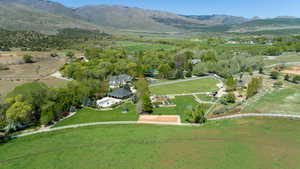 Overview of rural landscape featuring a mountain backdrop and agricultural land