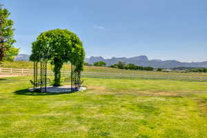 View of yard featuring a mountain view, a view of rural / pastoral area, and a patio