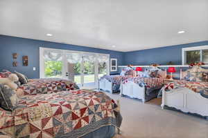 Carpeted bedroom featuring access to exterior, multiple windows, and recessed lighting