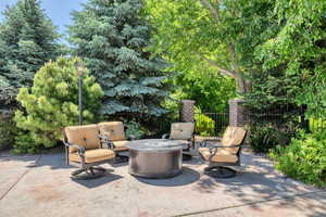 View of patio featuring an outdoor living space with a fire pit