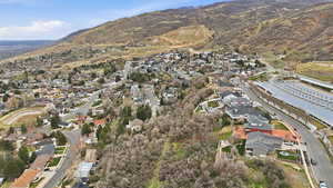 Aerial view of property's location with nearby suburban area and mountains