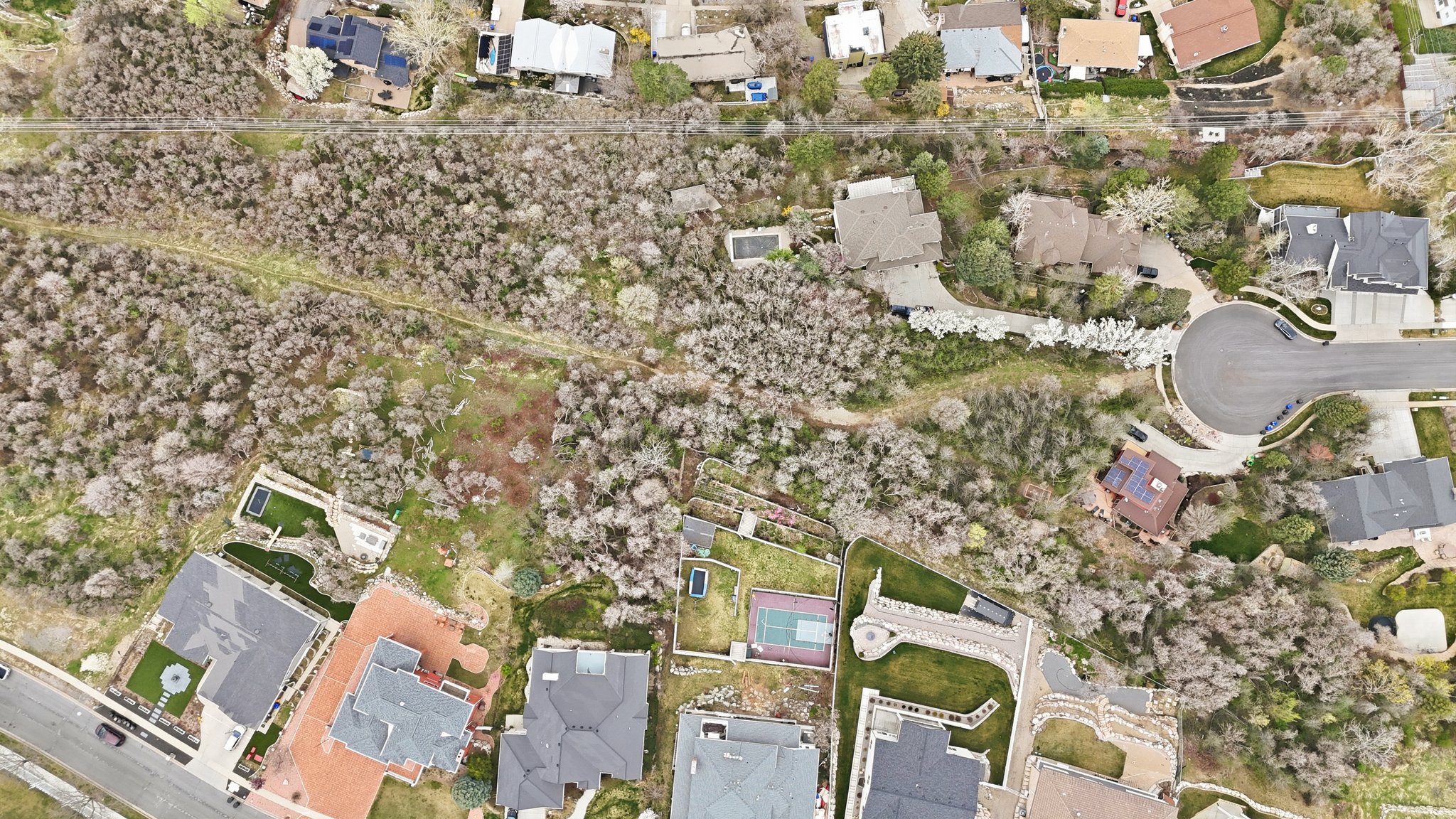 Aerial view of property and surrounding area featuring nearby suburban area