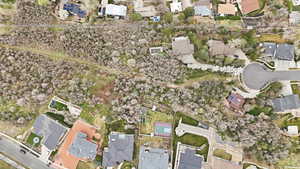 Aerial view of property and surrounding area featuring nearby suburban area