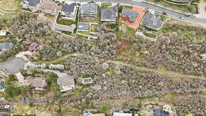 Aerial view of property and surrounding area featuring nearby suburban area