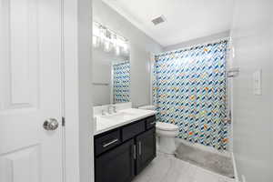 Bathroom featuring vanity and light marble finish flooring