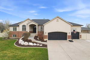 Ranch-style house featuring brick siding, an attached garage, concrete driveway, and stucco siding