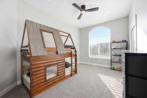 Bedroom with light carpet and a ceiling fan