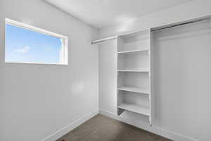 Walk in closet featuring carpet flooring